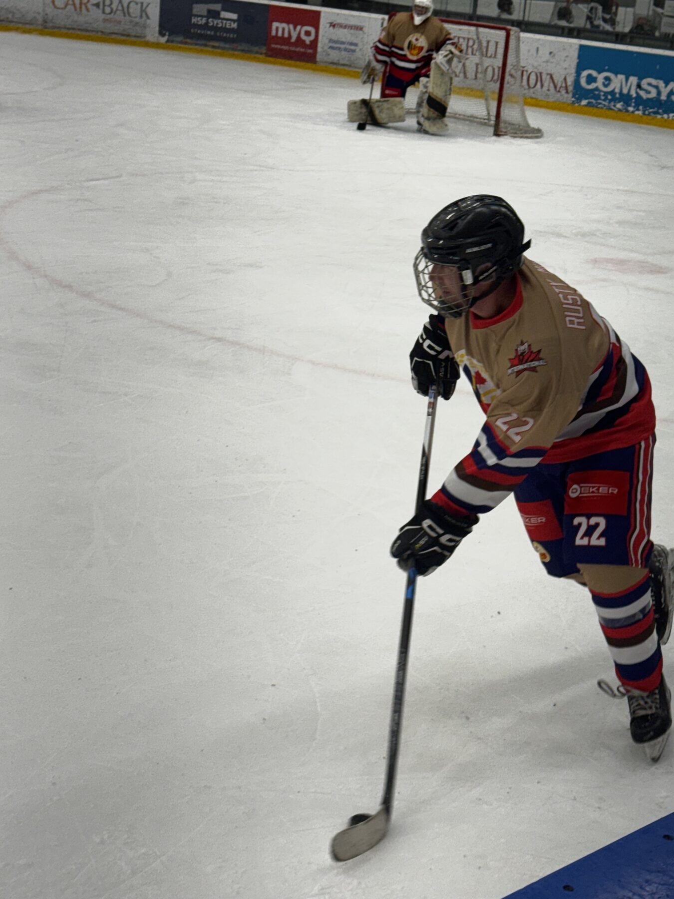 Rusty Mitts #22 driving the puck toward the Czech net
