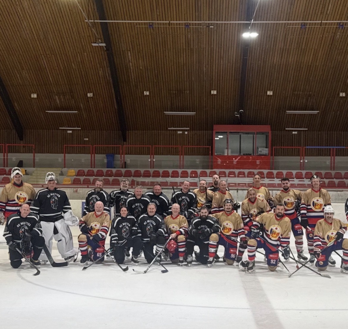 Rusty Mitts and HC Mutter squads together at center ice after the game